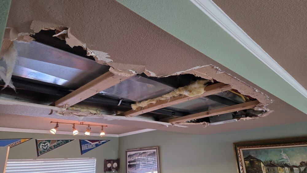 Ceiling drywall and framing exposed during a renovation project