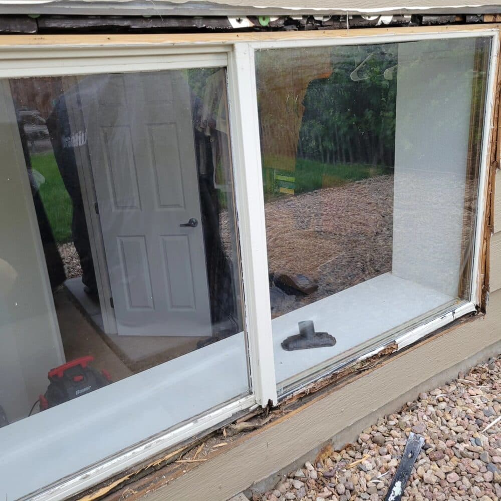 Installed sliding glass doors and frame on an outbuilding with white trim