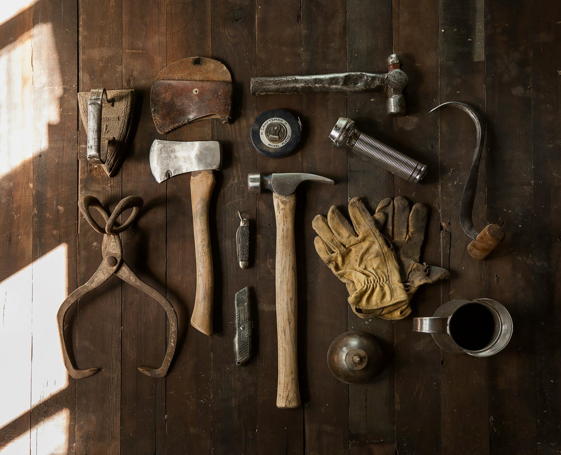 Handyman tools laid out on rustic dark wood